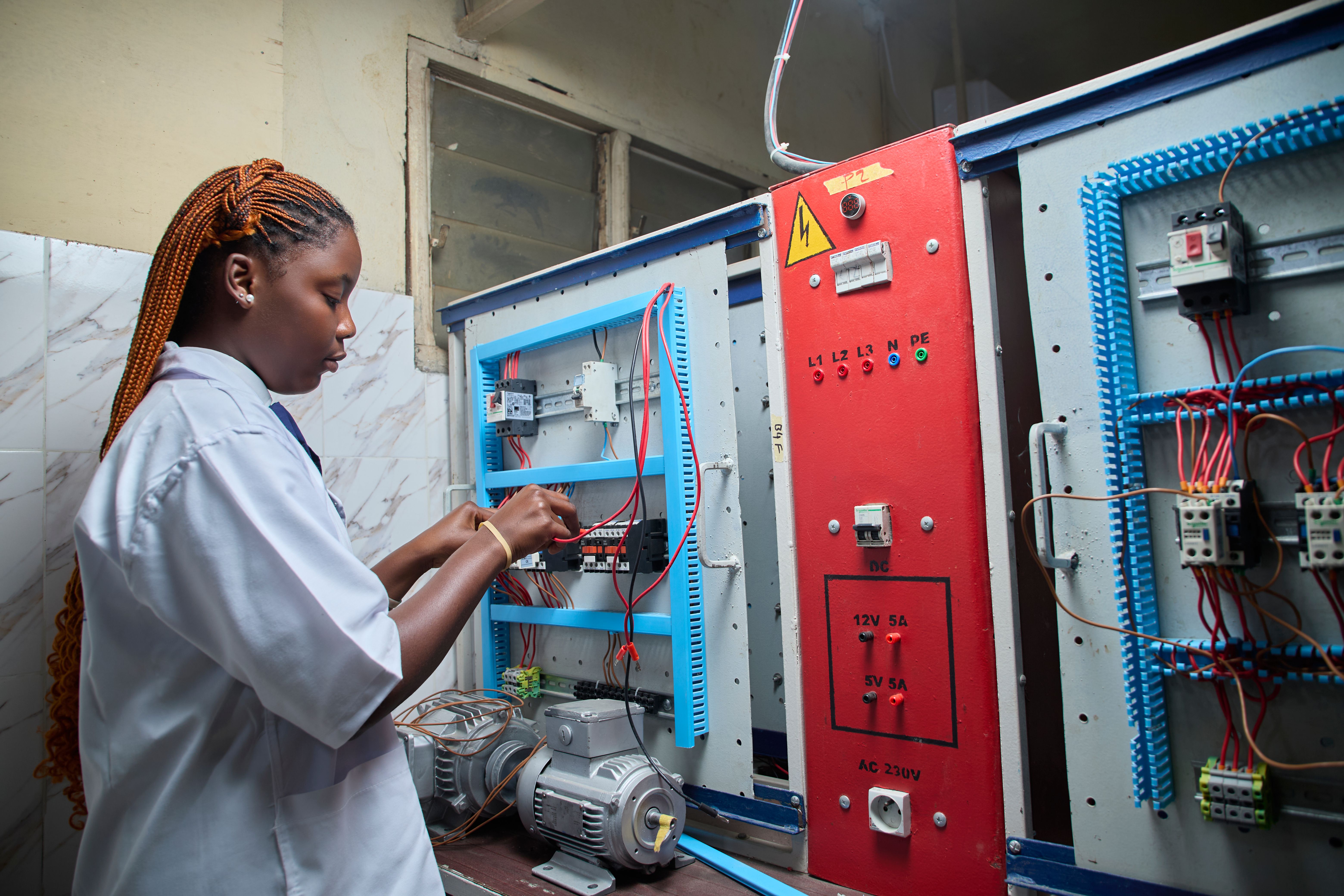 Technician wiring an electrical control panel