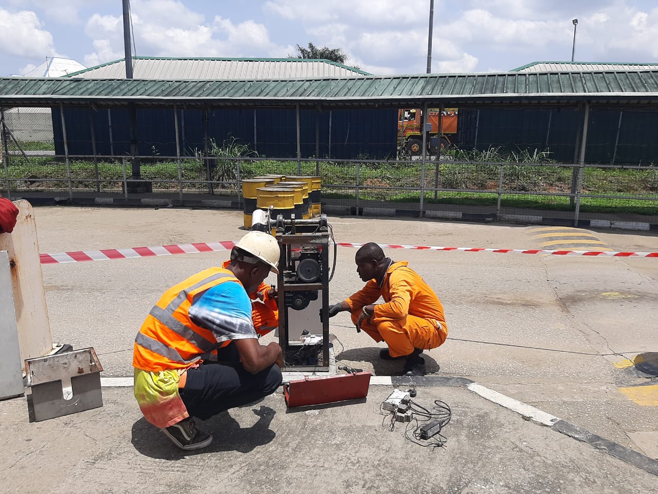 Technicians working on an electrical unit